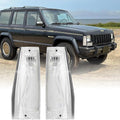 A pair of clear plastic front bumper reflectors shown in the foreground against a background photo of a black Jeep Cherokee outdoors on a dirt road.