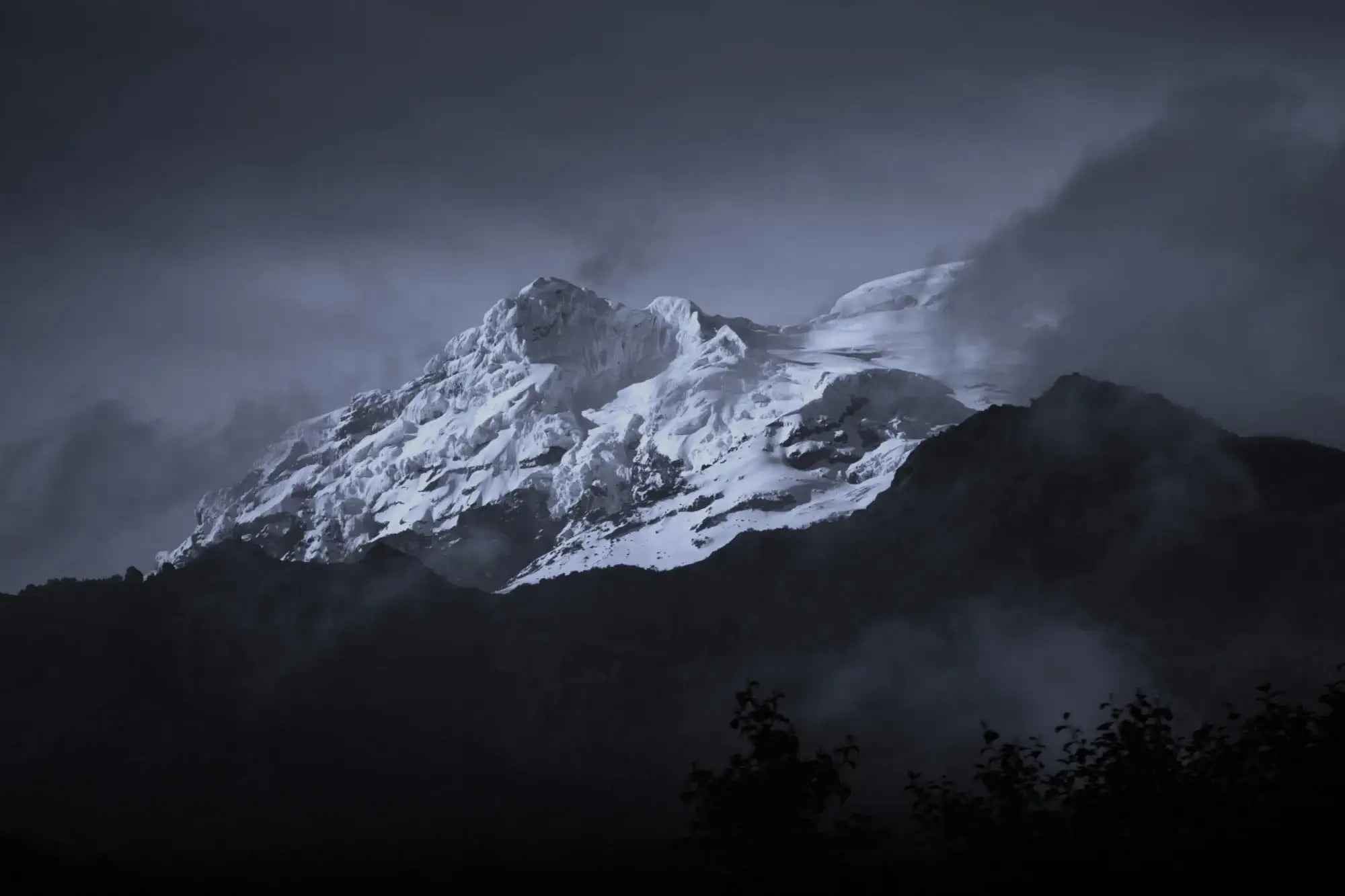 Snowcapped mountain peak with dark clouds and misty atmosphere in Lebanon